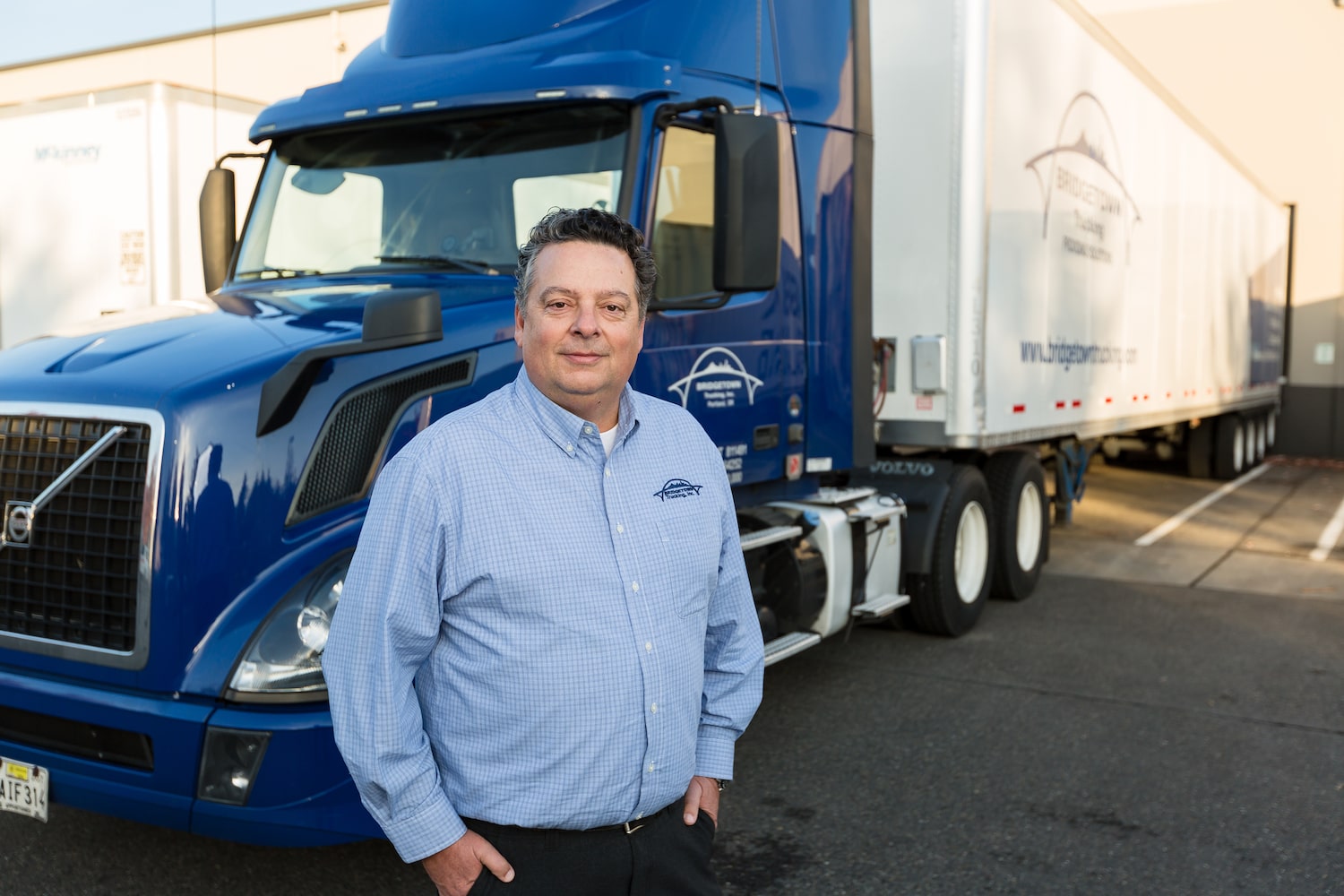 CEO Dave Chalmers standing in front of Bridgetown distribution truck