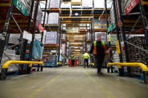 Blurred workers moving in a stocked warehouse
