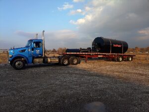 St. Louis flatbed truck carrying large tank.