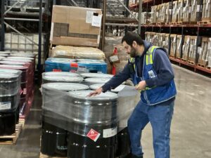 Bridgetown warehouse worker confirms order details.